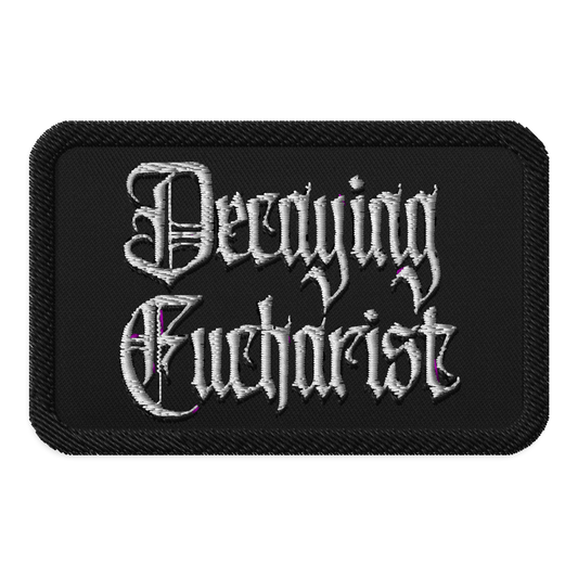 The Decaying Eucharist "Logo" Embroidered Patch by Mainstay Entertainment is a black rectangular patch featuring ornate white gothic lettering and subtle purple accents.