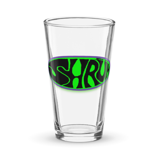 The SHRÜM "Logo" Pint Glass by Mainstay Entertainment is a clear 16 oz shaker pint featuring a green and black oval logo with SHRUM in bold, wavy letters at the center.