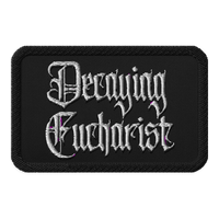 The Decaying Eucharist "Logo" Embroidered Patch by Mainstay Entertainment is a black rectangular patch featuring ornate white gothic lettering and subtle purple accents.