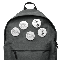 The Decaying Eucharist "Logo" Set of 5 Buttons by Mainstay Entertainment includes scratch and UV-resistant pin buttons: three with decorative black text and two with black abstract designs on white, all attached to a gray backpack.