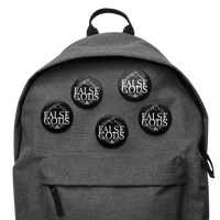 A gray backpack features five Mainstay Entertainment False Gods "Snake Logo" buttons, each with a glossy finish and bold white uppercase text, attached to the front pocket for added style.