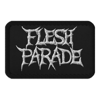 The Flesh Parade "Classic Logo" embroidered patch by Mainstay Entertainment is a black iron-on patch displaying “FLESH PARADE” in bold, jagged white letters styled in a heavy metal font.