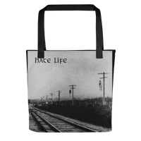 A black and white photo of train tracks with the Flesh Parade "Hate Life" Tote Bag by Mainstay Entertainment, capturing urban style in a timeless moment.