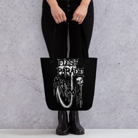 Wearing black pants and boots, a person holds the Flesh Parade "Meathook" Tote Bag V1 by Mainstay Entertainment, featuring a gothic skull design, in front of a light speckled background.