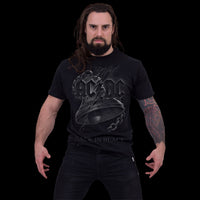 A man with long dark hair and a beard stands with arms slightly out, wearing the Spiral USA AC/DC 