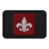 The Mainstay Entertainment "Fleur de Lis" Embroidered Patch is a black rectangular iron-on patch with a red square center and a white embroidered fleur-de-lis symbol.