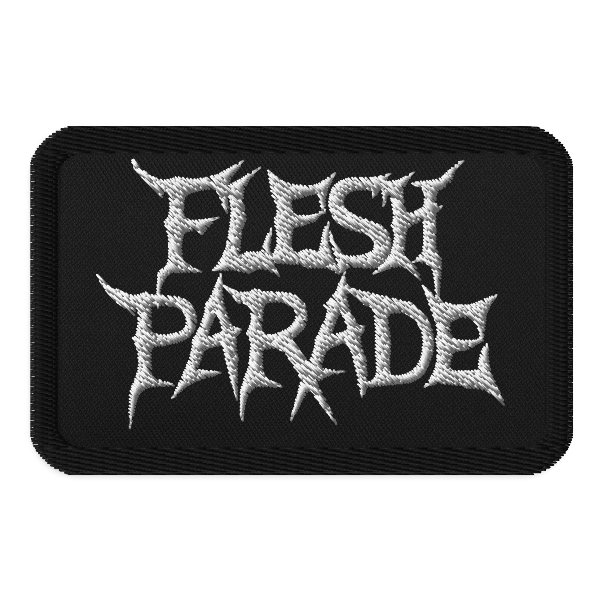The Flesh Parade "Classic Logo" embroidered patch by Mainstay Entertainment is a black iron-on patch displaying “FLESH PARADE” in bold, jagged white letters styled in a heavy metal font.