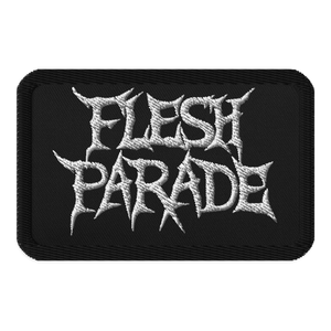 The Flesh Parade "Classic Logo" embroidered patch by Mainstay Entertainment is a black iron-on patch displaying “FLESH PARADE” in bold, jagged white letters styled in a heavy metal font.