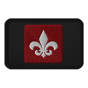 The Mainstay Entertainment "Fleur de Lis" Embroidered Patch is a black rectangular iron-on patch with a red square center and a white embroidered fleur-de-lis symbol.