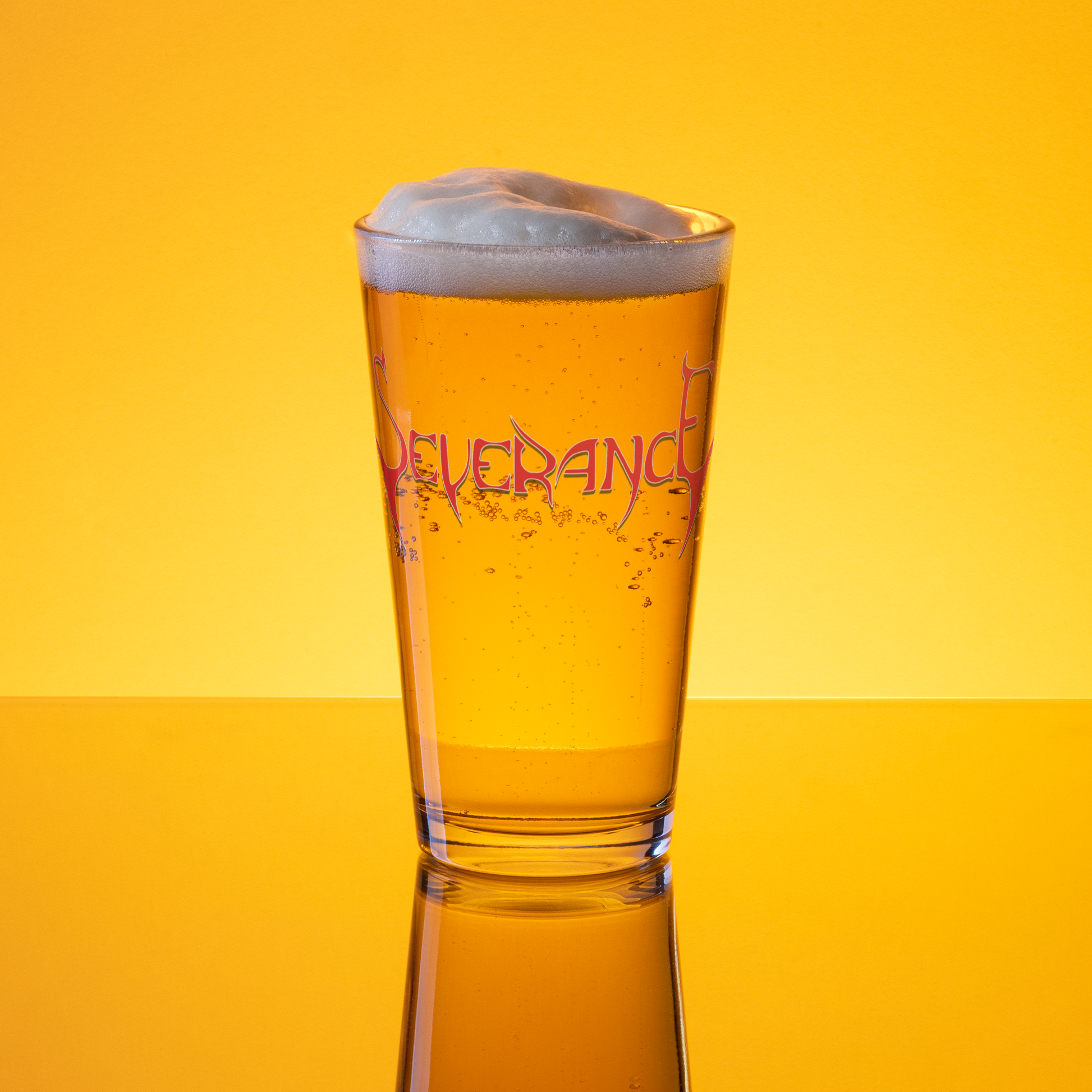 The Severance "Logo" Pint Glass by Mainstay Entertainment holds 16 oz, featuring stylized SEVERANCE lettering. Shown filled with golden beer and a foamy head, it stands against a bright yellow background.
