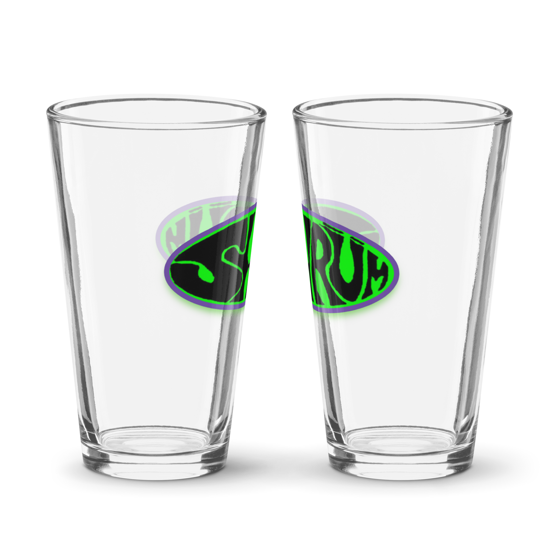 Two empty clear 16 oz SHRÜM "Logo" Pint Glasses by Mainstay Entertainment sit side by side on a plain white background, each displaying a green and purple SERUM logo in stylized text on the front.