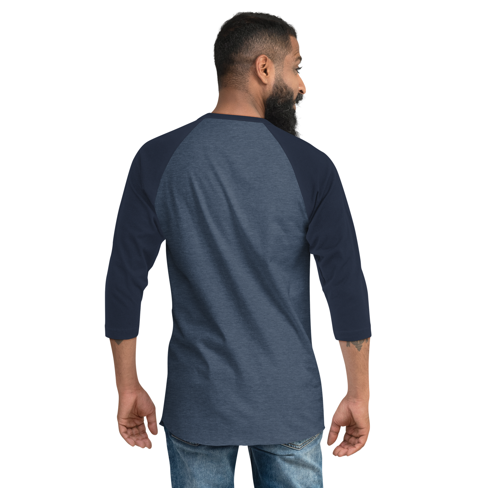 A bearded man is seen from behind wearing a Mainstay Entertainment Noz Redna "Candle Logo" 3/4 Sleeve Raglan Shirt and blue jeans, standing against a plain light background.