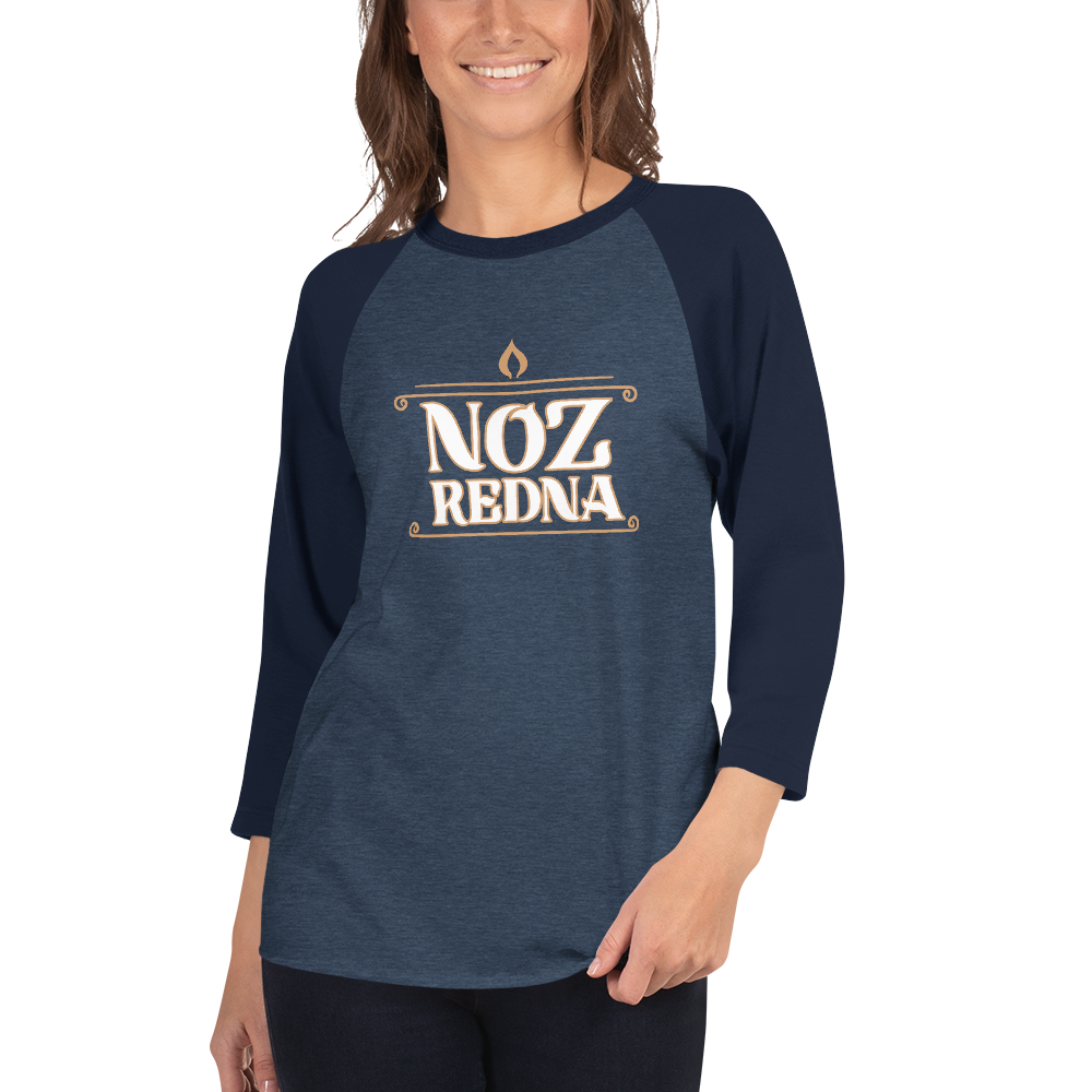 A smiling person wears the Mainstay Entertainment Noz Redna "Candle Logo" 3/4 Sleeve Raglan Shirt—navy cotton blend with long dark sleeves, bold NOZ REDNA text, and a small flame icon on the front.